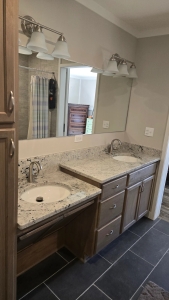 Modern master bathroom renovation with a zero-entry walk-in shower and seamless tile floor transition for trip-free movement.