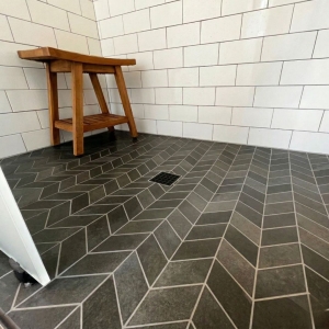 Custom herringbone slate bathroom floor installation by ContractorMen in North Georgia.