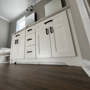 Bathroom remodel with new white vanity and high quality LVP in Cumming GA.